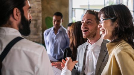 Co-workers arguing standing up to improve the economic results of the company