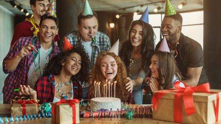 Happy friends congratulating girl on surprise birthday party, copy space